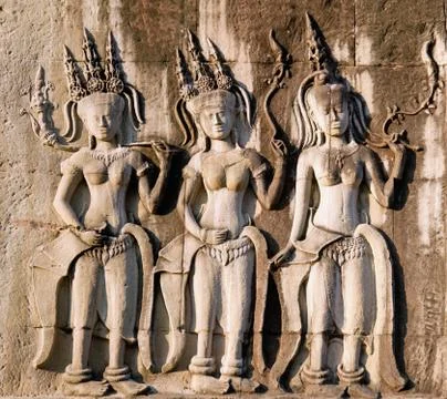 Three dancing apsara on the wall in angkor wat Stock Photos