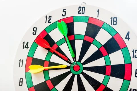 Three dart arrows next to the target on a white background. Achieving goal. Stock Photos