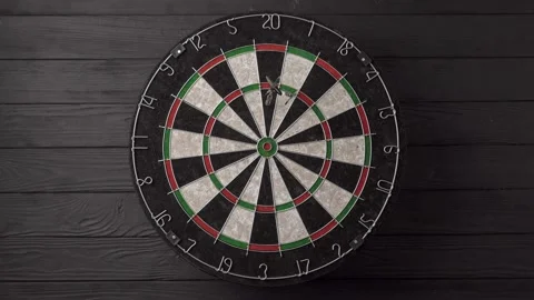 Three darts hit the dartboard on a black wooden background. Unlucky - none of Stock Footage 237873228