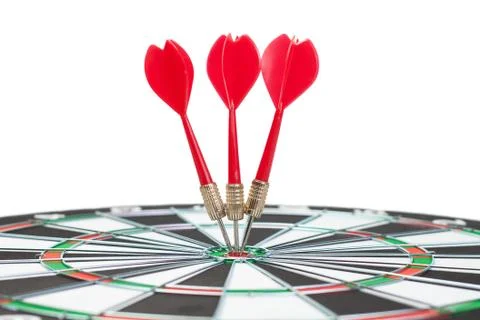 Three darts hit the dead centre of target Stock Photos