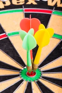 Three darts in the target center Stock Photos