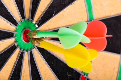 Three darts in the target center Stock Photos