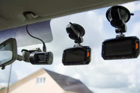 Three dashboard camera mounted on the dirty front windshield, recording the t Stock Photos