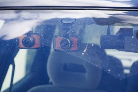Three dashboard camera mounted on the dirty front windshield. Car Camera DVR  Foto stock