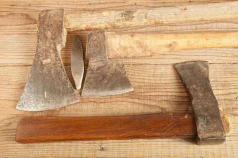 Three dated and used cleavers on wooden background Stock Photos