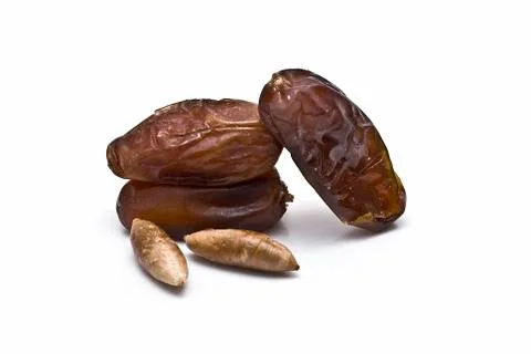 Three dates and seeds. Stock Photos