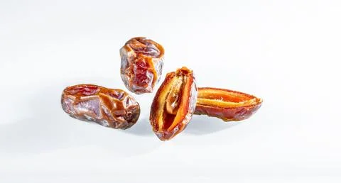 Three dates with shadows on a white background close-up Stock Photos