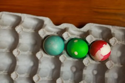 Three decorated easte eggs in a paper tray Stock Photos
