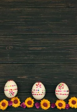 Three decorated easter eggs on wooden background. Postcard with space for text Stock Photos