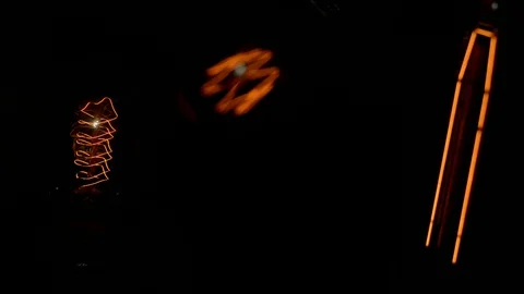Three decorative filament light bulbs gradually switch on and off Stock Footage 127886565
