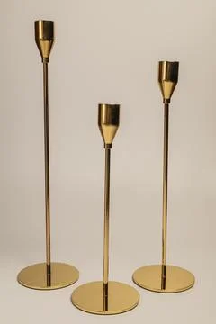 Three decorative golden candlesticks . Stock Photos