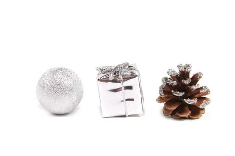 Three decorative objects for christmas - ball, gift and pinecone Foto stock