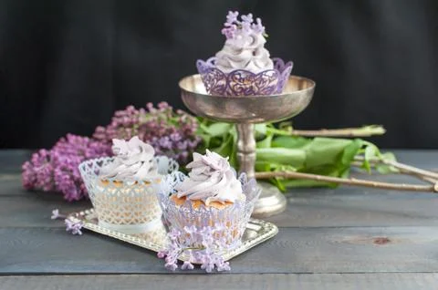 Three delicious cupcakes on a table Stock Photos