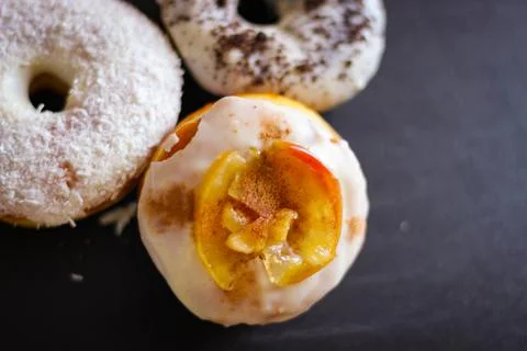 Three delicious Donuts on a black background Stock Photos