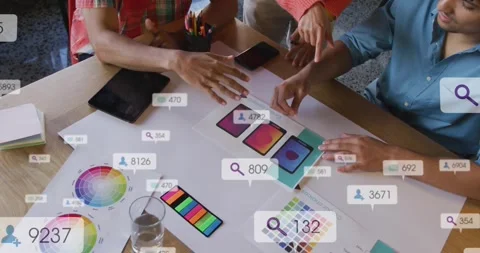 Three designers reacting to floating UI bubbles, aligning phone mockups on teal Stock Footage 330160596