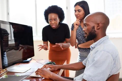 Three developers having heated discussion reviewing code, working together tech Stock Photos