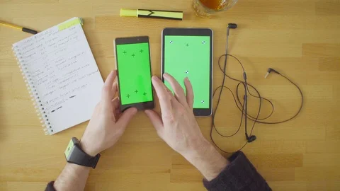 Three devices with green screens on the table Video stock 88821940