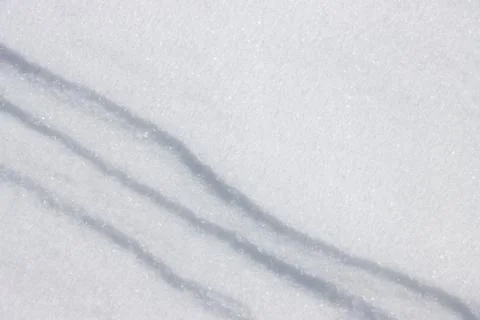 Three diagonal straight lines in fresh white flat snow surface 写真素材