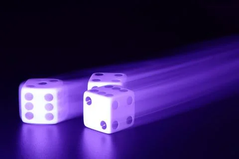 Three dice with motion blur Stock Photos