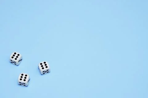 Three dice with the same dropped out numbers lie on a blue background Stock Photos