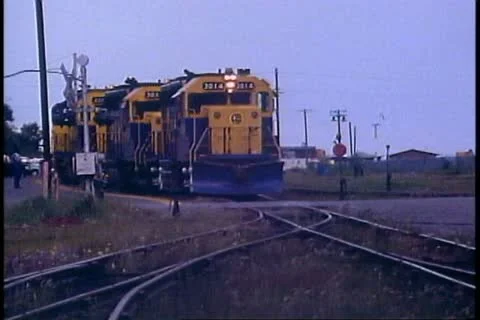 Three diesel locomotives in a row, crushed shot, head on, gray sky Stock Footage