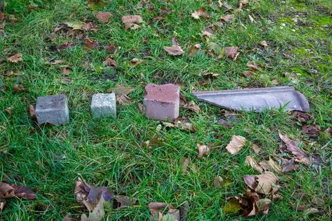 Three different blocks or cobblestones next to a piece of broken grey clay Stock Photos