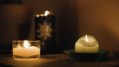 Three different candles burns indoor at home in dusk. Stock Footage 235563491