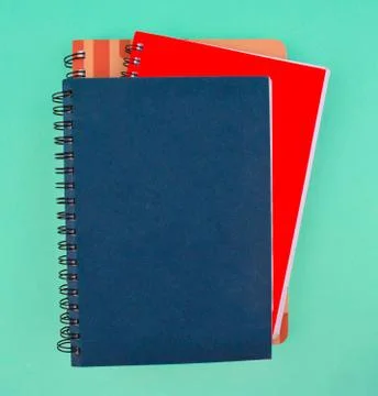Three different color note paper diary placed on top of each other on a paper Stock Photos