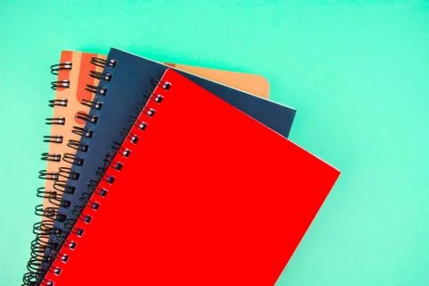 Three different colored note paper diary placed on top of each other on a blu Foto stock