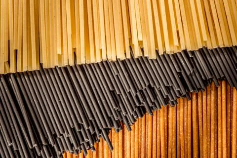 Three different colours of raw spaghetti Stock Photos