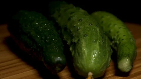 Three different cucumbers are spinning on the board. Stock Footage 104657303