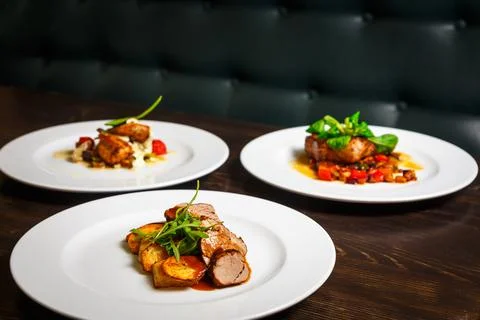 Three different dishes of chicken, beef and pork Stock Photos