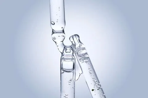 Three different face serum pipettes on a neutral background. Stock Photos