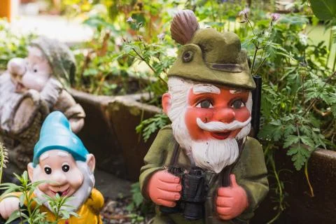 Three different garden gnomes representing different moments Foto stock