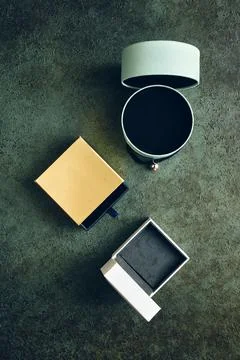 Three different gift boxes on green textured background toned in retro style Stock Photos