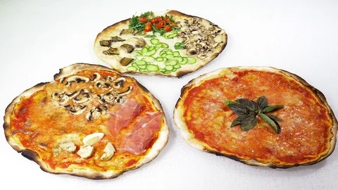 Three different italian pizza on table 4K Stock Footage 78116171