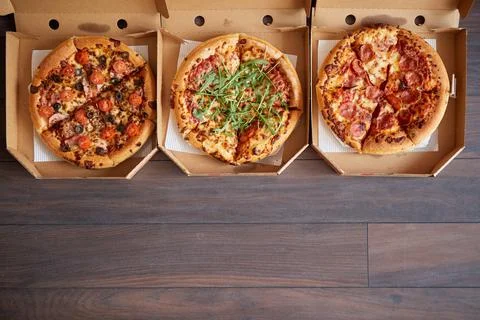 Three different kind of pizzas in delivery boxes Stock Photos