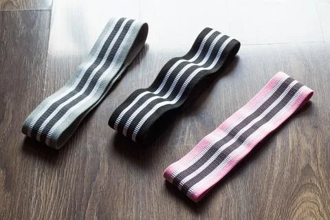 Three different level resistance bands. Pink, black and gray resistance bands Foto stock