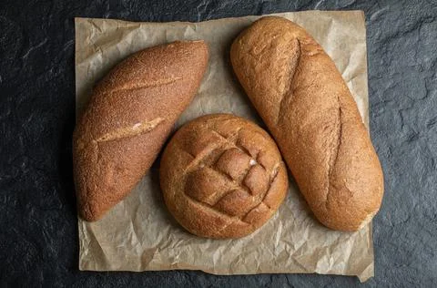 Three Different loaves bread on black background Stock Photos