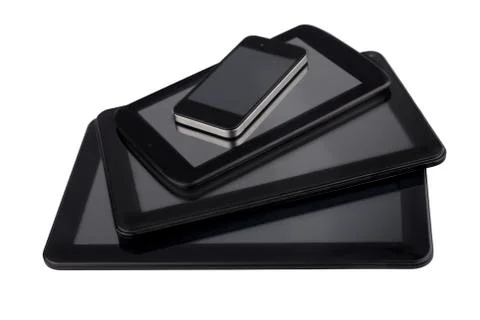 Three different sizes of tables and smartphone Stock Photos