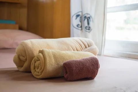 Three different towels size on the bed Stock Photos