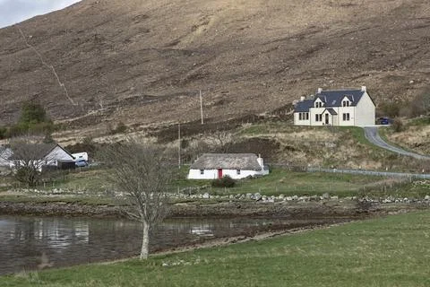 Three different type sof cottages by the side of a loch Stock Photos