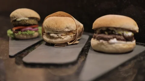 Three Different Types of Burgers on Dinner's Balcony Stock Footage 128987136