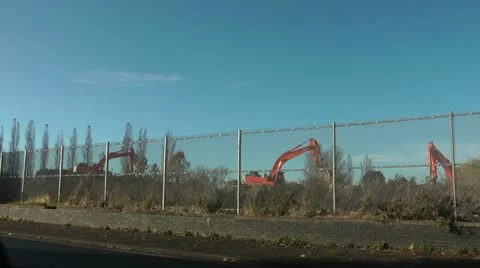 Three diggers under blue sky on demolition site Stock Footage 14818107