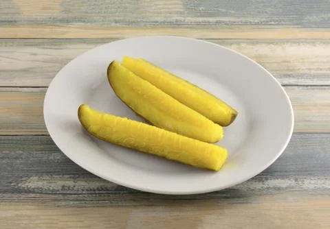 Three dill pickle spears Stock Photos