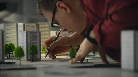 Three-dimensional. The bespectacled tech developer is creating new buildings Stock Footage 269231360
