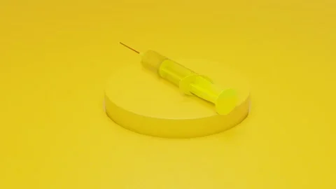 A three-dimensional model of a yellow disposable syringe rotates on a yellow pod Stock Footage 166618608