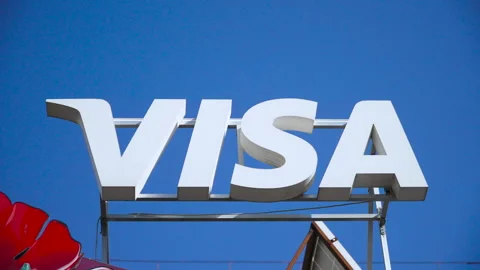 Three dimensional white letters of Visa company on rooftop against blue sky. Stock Footage 330534878