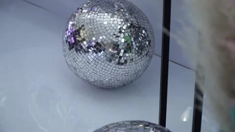 Three disco balls lie on the white floor at a corporate party Stock-Footage 151690645