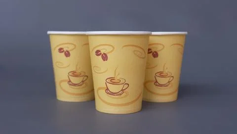 Three Disposable Coffee Paper Cups on Dark Gray Background Stock Photos